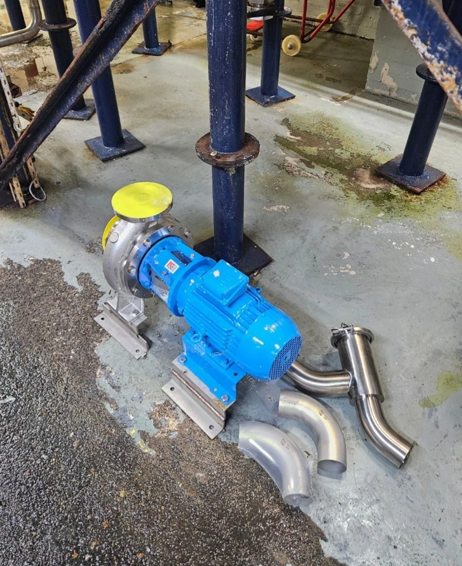 Blue pump beside stainless steel pipe bends ready for fitting