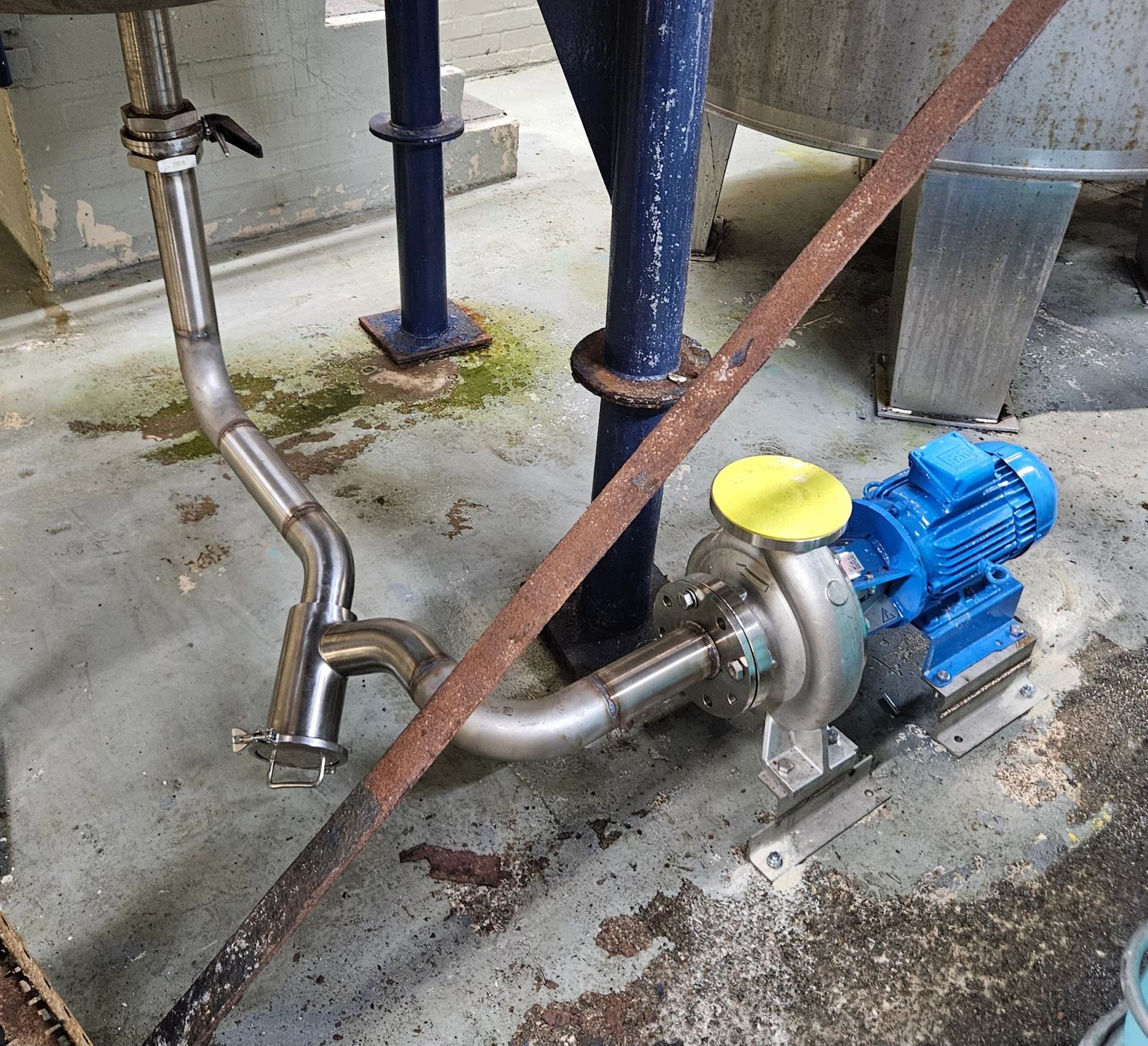 Blue pump fitted with new stainless steel pipework under a tank
